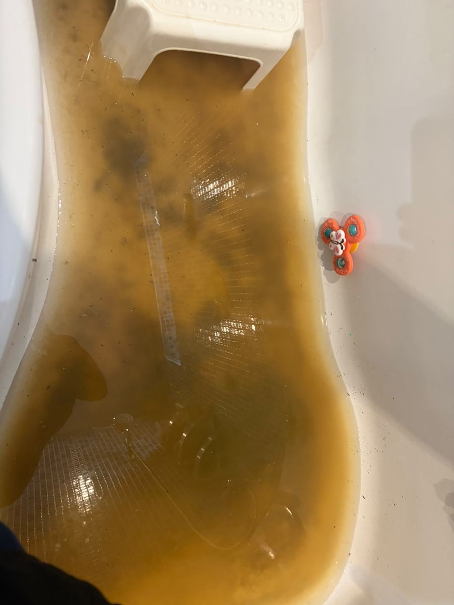 Bath filled with dirty water from a blocked waste