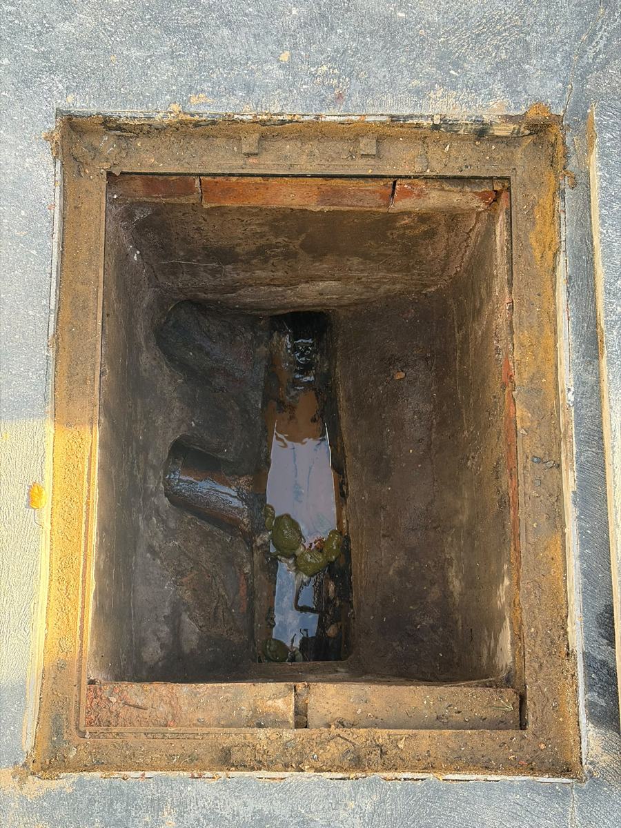 Inspection chamber with debris and standing water